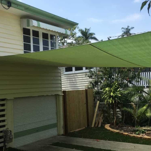 Brisbane-shade-sail-1-x-4-point-shade-sail-attached-to-Queenslander-1 Indooroopilly, Brisbane - Shade sail installation of 1 x 4 point shade sail attached to a Queenslander home with sail track and powder-coated posts. Installed by Superior Shade Sails.