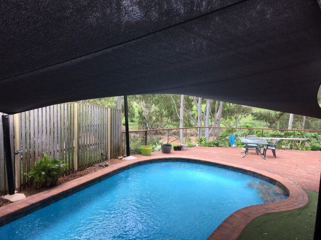 Pool shade sail installation at Barellan - 6 point sail with sail track for pool and leaf cover by Superior Shade Sails, Brisbane