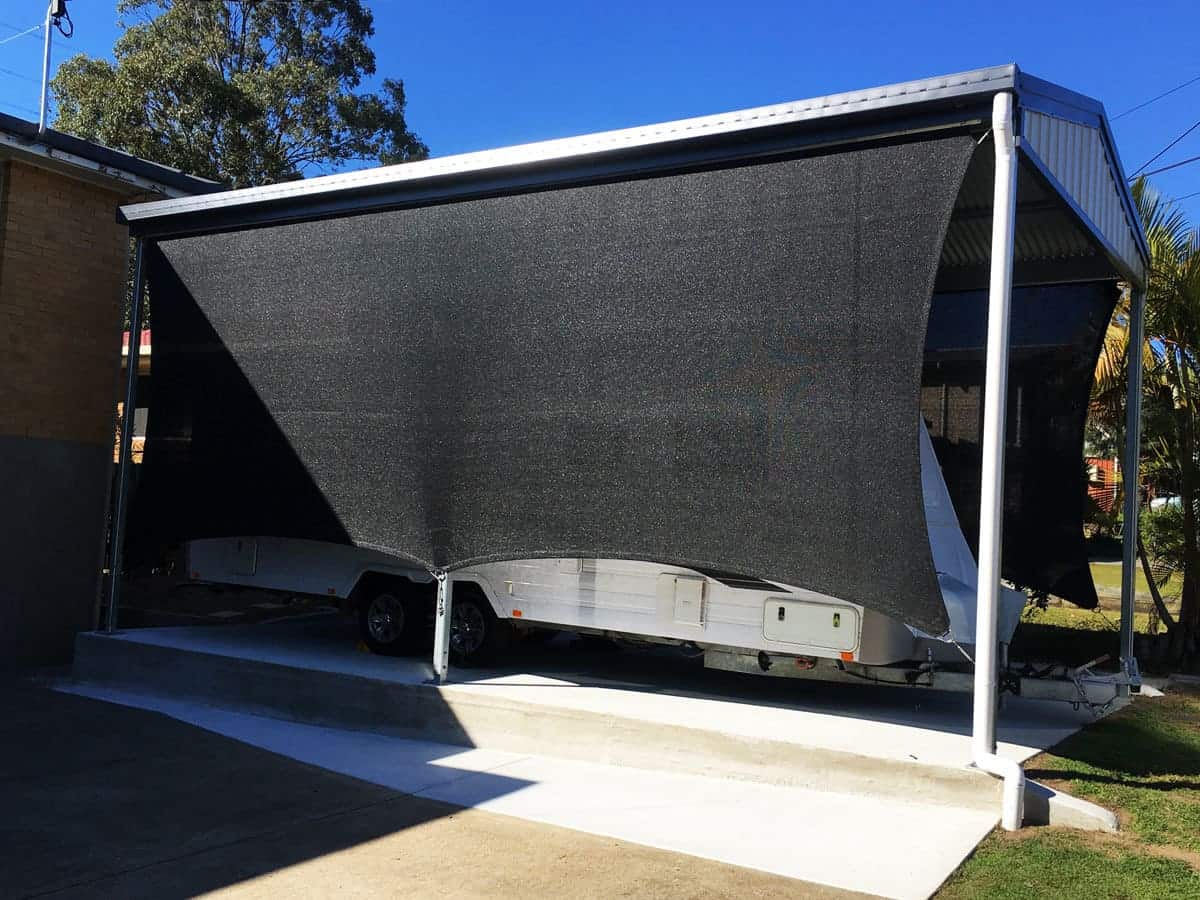 Goodna-Carport sun sail in black Abshade material - 316 marine grade wire and rigging - creating vertical block out screens.