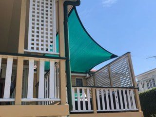 Patio Shade Sail -To keep the family BBQ out of the sun for this Queenslander in Nundah, Brisbane.We used the Rainbow Z-16 sail fabric in the colour Rainforest and 316 marine grade trace wire with two roof brackets attached.