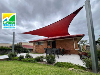 With the installation of this 4-point shade sail in striking Red Earth Z-16 shade cloth, this lovely home now boasts a lovely outdoor living space.