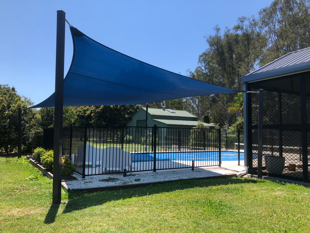 Pool shade sail in z16 in Navy Blue Pool shade sail in z16 shade fabric in Navy Blue perfect for the summer days installed by Superior Shade Sails.